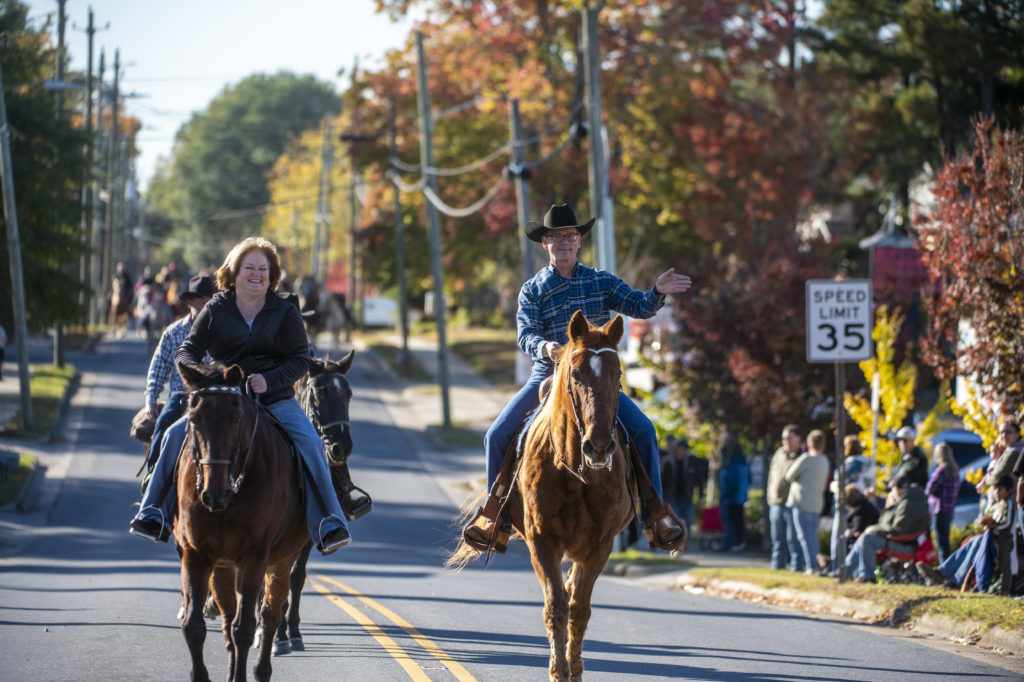 Shelia Robbins Scott and Rick Scott lead the way of over 100 horses down Sunset drive during the 20th annual Asheboro Fall Roundup Horse Parade in downtown Asheboro, on Nov. 7, 2021. (PJ WARD-BROWN/NORTH STATE JOURNAL)