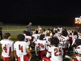 Hoke County’s football team huddles up for instructions during last Friday’s Cumberland County Jamboree. (Hal Nunn for North State Journal)