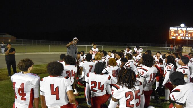 Hoke County’s football team huddles up for instructions during last Friday’s Cumberland County Jamboree. (Hal Nunn for North State Journal)