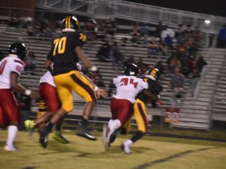 Dontrell Mims (34) records one of his two tackles for loss in the Bucks’ blowout win over Douglas Byrd on Friday. . (Hal Nunn for North State Journal)