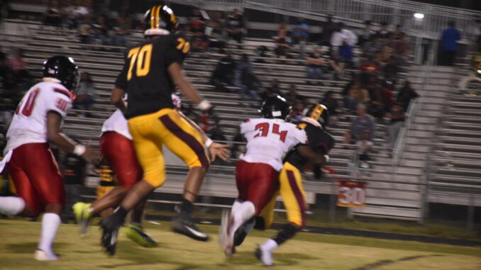 Dontrell Mims (34) records one of his two tackles for loss in the Bucks’ blowout win over Douglas Byrd on Friday. . (Hal Nunn for North State Journal)