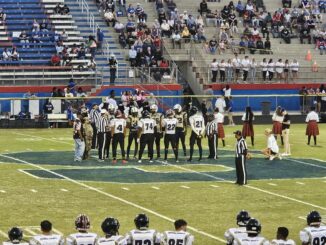 Hoke’s team captains meet their counterparts with Scotland for the pregame coin toss. The Bucks led a back-and-forth game into the fourth quarter but came up short on the road against the Scots. (Hal Nunn for North State Journal)